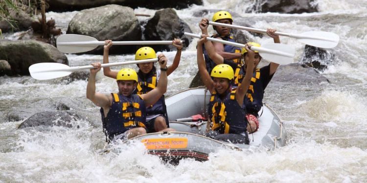 Bali Rafting & ATV Tour – Jungle Adrenaline Experience Adventure travelers riding ATVs through tropical Bali terrain